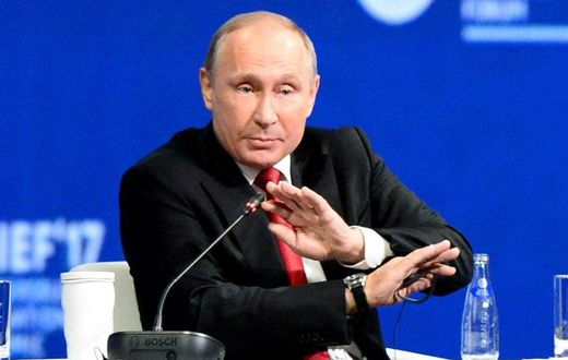 Russian President Vladimir Putin, seen here at an economic forum, tells a US television interviewer he barely spoke to former US national security advisor Michael Flynn when they met at an event in Moscow sponsored by Russian television network RT