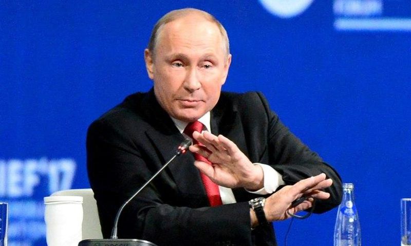 Russian President Vladimir Putin, seen here at an economic forum, tells a US television interviewer he barely spoke to former US national security advisor Michael Flynn when they met at an event in Moscow sponsored by Russian television network RT