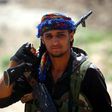 A Syrian Democratic Forces fighter in the Islamic State group's Syrian bastion of Raqa after seizing the Al-Romaniya area on June 11, 2017
