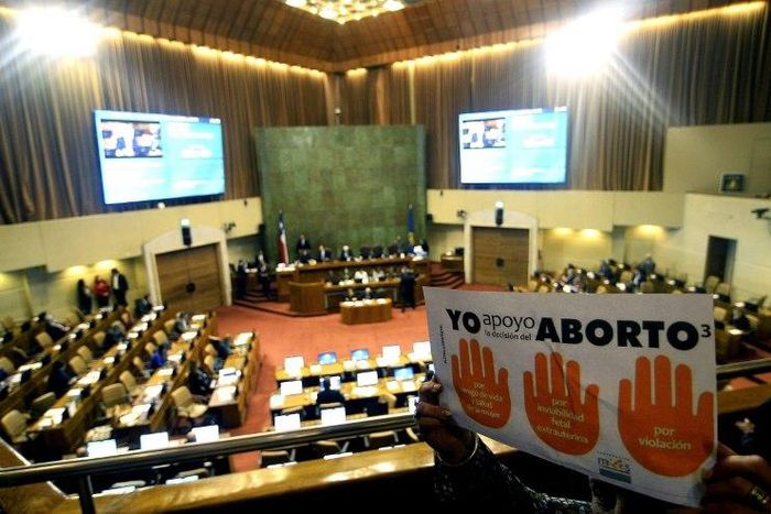 Activists holding placards supporting abortion take part in a demonstration inside the National Congress in Valparaiso, Chile, on July 20, 2017