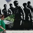 Graffiti in Athens by French street artist Goin. Greece's return to the bond markets is a psychological milestone, demonstrating that the country is back on the road to weaning itself off bailout aid