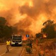 Firefighters get to work in the Annunziata district of Messina as a fire rages on July 10, 2017