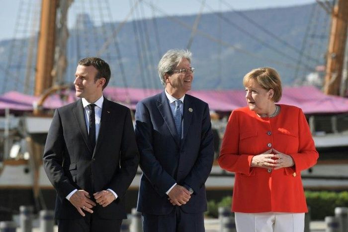 Italy's Prime Minister Paolo Gentiloni (C) met with German Chancellor Angela Merkel (R) and French President Emmanuel Macron (L) in Trieste before an annual Western Balkans summit