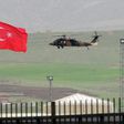 A helicopter files over the Habur border crossing, in Sirnak