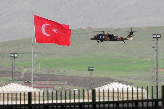 A helicopter files over the Habur border crossing, in Sirnak