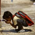 A Syrian child who has fled the Islamic State group's stronghold of Raqa, drinks water at a camp for internally displaced people in Ain Issa