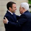 French President Emmanuel Macron (L) greets Palestinian President Mahmoud Abbas prior to their meeting at the Elysee Palace in Paris, on July 5, 2017
