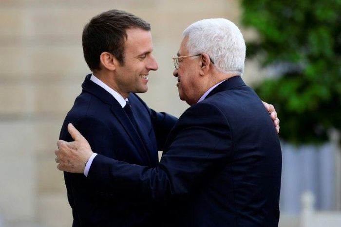 French President Emmanuel Macron (L) greets Palestinian President Mahmoud Abbas prior to their meeting at the Elysee Palace in Paris, on July 5, 2017