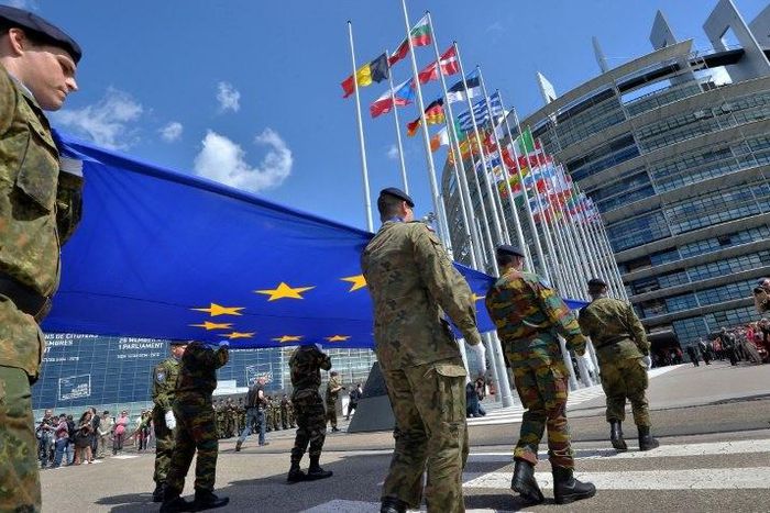 Soldiers of a Eurocorps detachment carry the EU flag in front of the European Parliament in Strasbourg, eastern France