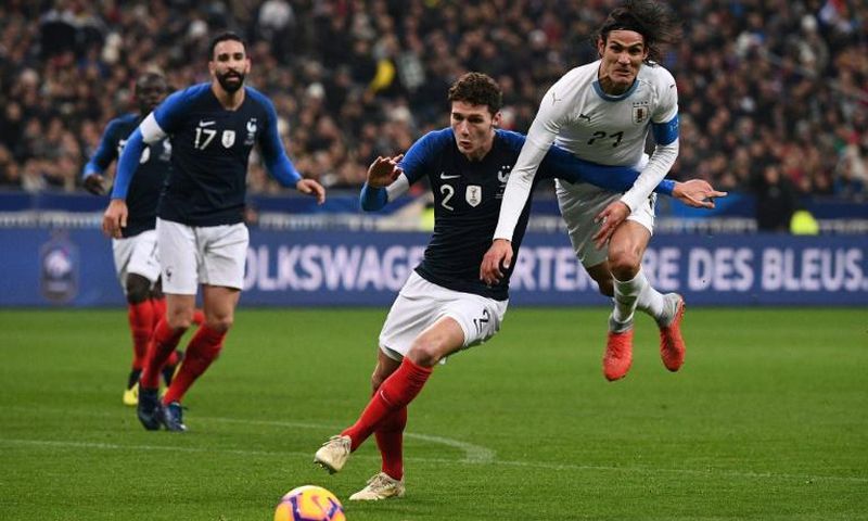 France defender Benjamin Pavard (C) vies with Uruguay forward Edinson Cavani during a November 20 friendly at the Stade de France.