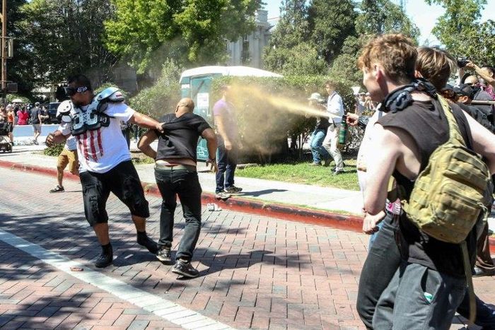 Joey Gibson (black t-shirt), leader of the alt-right Patriot Prayer group, gets pepper sprayed by leftist counter demonstrators in Berkeley, California