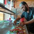 A Syrian man prepares food at the Ibad al-Rahman's Damascene Delicacies in the rebel-controlled northern city of Idlib on July 19