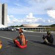 Brazilian indigenous people block a road as they sit in front of the National Congress during the annual march for their rights, in Brasilia, on April 25, 2017