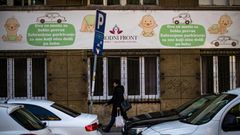 A woman walks in front of a maternity hospital in Belgrade. The government wants to boost the country's birth rate of 1.5 children per family, one of the lowest in Europe