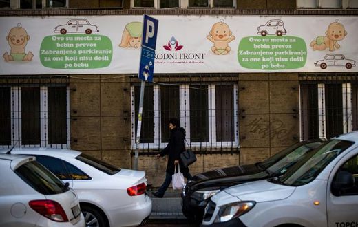 A woman walks in front of a maternity hospital in Belgrade. The government wants to boost the country's birth rate of 1.5 children per family, one of the lowest in Europe