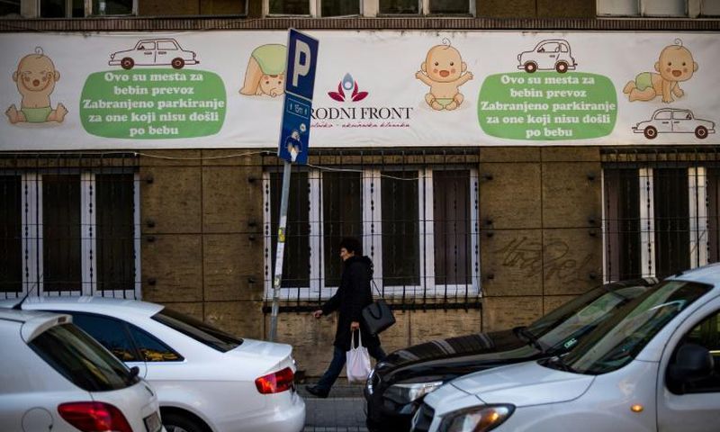 A woman walks in front of a maternity hospital in Belgrade. The government wants to boost the country's birth rate of 1.5 children per family, one of the lowest in Europe