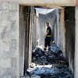 A firefighter walks in a burnt-out house in the village of Zrnovnica, near the Adriatic coastal town of Split in July 2017