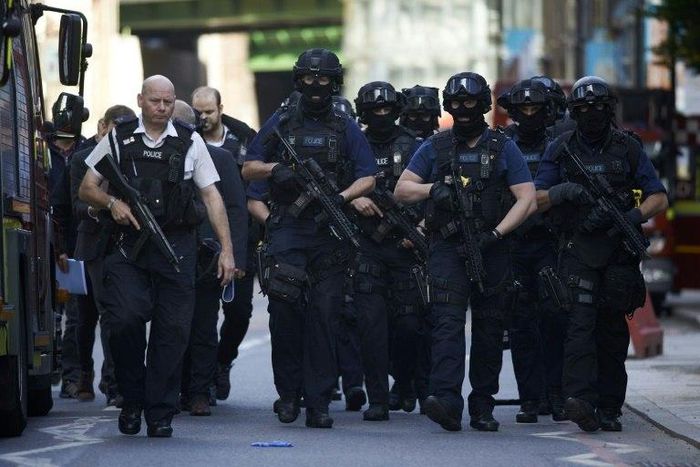 Armed police officers patrol on the streets of London on June 4, 2017 following a terror attack the previous evening