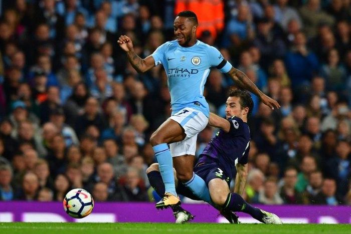Manchester City's Raheem Sterling (L) fights for the ball with Everton's Leighton Baines during their English Premier League match, at the Etihad Stadium in Manchester, on August 21, 2017