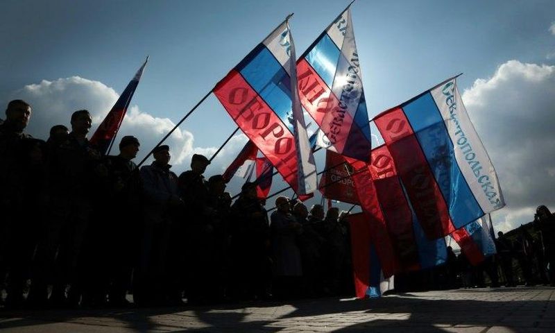 People wave Russian national flag as they celebrate the third anniversary of the annexation of the Crimea by the Russian Federation in Sevastopol in March 2017