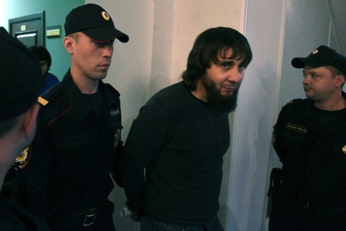 Zaur Dadayev, one of five defendants found guilty by a Moscow court over the 2015 murder of Russian opposition leader Boris Nemtsov, seen here being escorted by police officers on June 22.