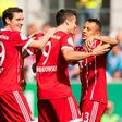 Munich's forward Robert Lewandowski (C) celebrates after scoring the first goal with midfielder Sebastian Rudy (L) and defender Rafinha during the German football Cup DFB Pokal first round match against Chemnitzer FC August 12, 2017