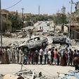 Iraqis stand in line to receive food aid in west Mosul's Zanjili neighbourhood as Iraqi forces battle to retake the city from Islamic State group jihadists