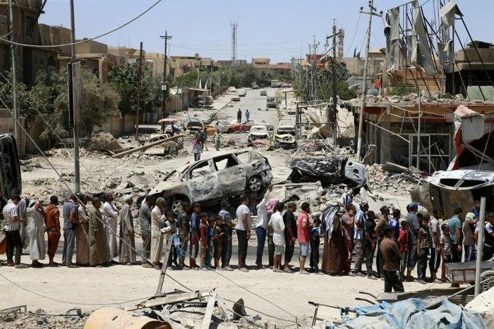 Iraqis stand in line to receive food aid in west Mosul's Zanjili neighbourhood as Iraqi forces battle to retake the city from Islamic State group jihadists