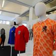 (From L) A football shirt from Italy, from the 80s, an England away shirt from 1966 and a Netherlands shirt from 1988, seen at 'The Art of the Football Shirt' exhibition in London, on July 26, 2017