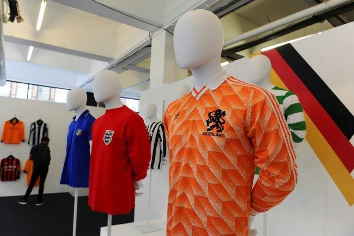 (From L) A football shirt from Italy, from the 80s, an England away shirt from 1966 and a Netherlands shirt from 1988, seen at 'The Art of the Football Shirt' exhibition in London, on July 26, 2017