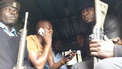 MP Benjamin Gathiru (in yellow shirt) at the back of a police Land Rover (twitter)