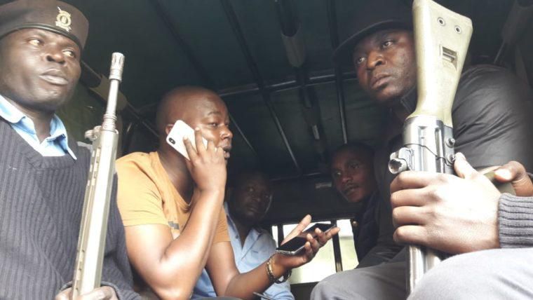 MP Benjamin Gathiru (in yellow shirt) at the back of a police Land Rover (twitter)