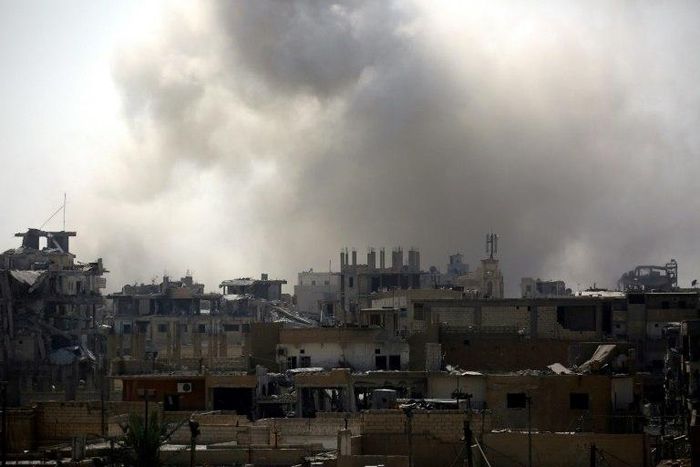 Smoke rises from building in Raqa's eastern al-Sanaa neighbourhood, on the edge of the old city, on August 13, 2017