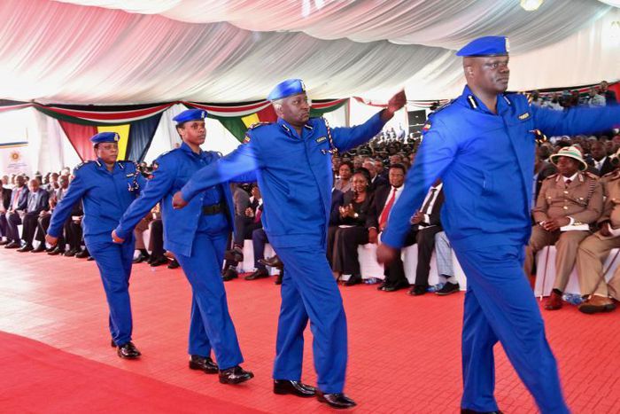 Police officers march in the new uniform unveiled by Uhuru