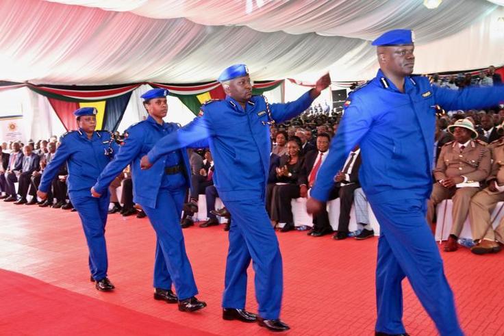Police officers march in the new uniform unveiled by Uhuru