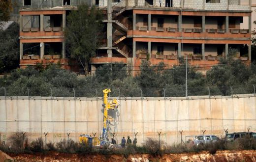 Israeli soldiers stand by machinery near the border wall with Lebanon on December 4, 2018 close to the northern Israeli town of Metula
