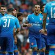 Arsenal's midfielder Theo Walcott (C) and teammates celebrate after Benfica's defender Lisandro Lopez scored an own goal on July 29, 2017