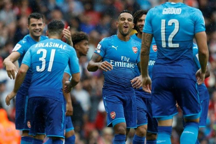 Arsenal's midfielder Theo Walcott (C) and teammates celebrate after Benfica's defender Lisandro Lopez scored an own goal on July 29, 2017