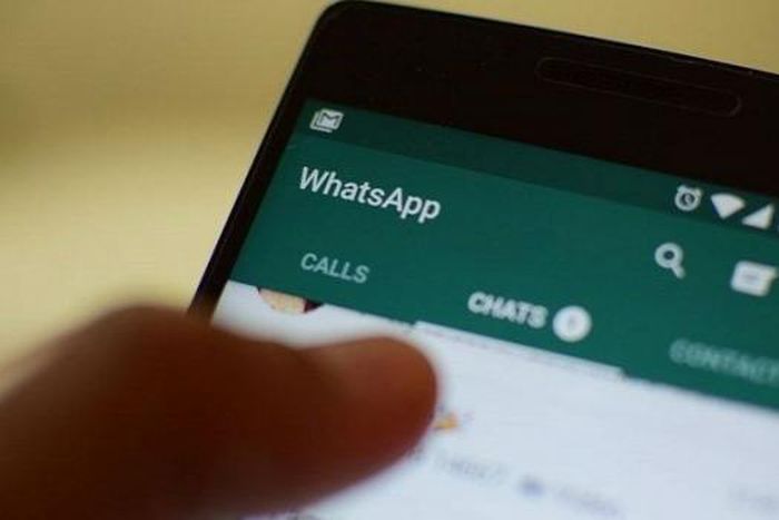 A user views WhatsApp messenger on his phone (twitter)