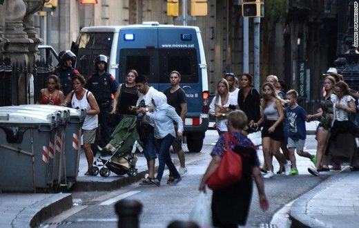 People flee the scene of the attack which occurred in Barcelona, Spain, on August 17, 2017.