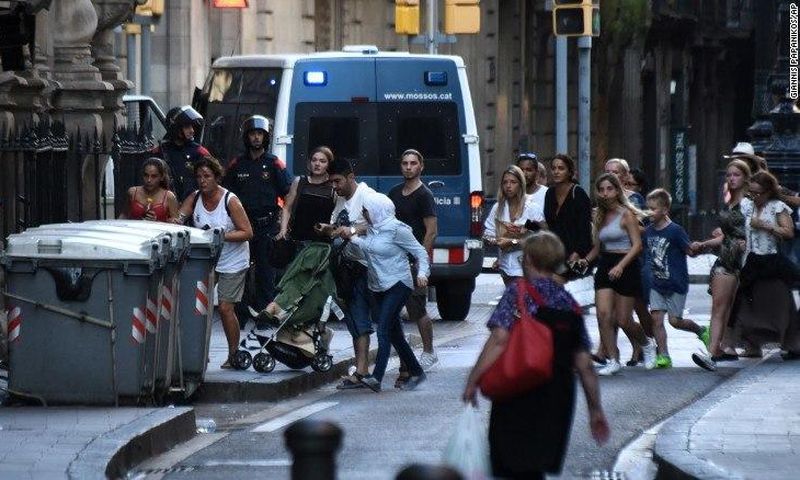 People flee the scene of the attack which occurred in Barcelona, Spain, on August 17, 2017.