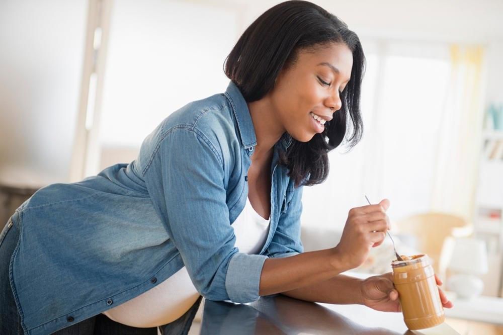 Pregnant woman eating peanut butter(Pulse)
