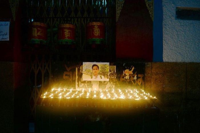 A photograph of Tibetan student Tenzin Choeying on display during a candlelight memorial in New Delhi, on July 23, 2017