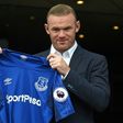 Wayne Rooney poses with the Everton shirt after his return to the club from Manchester United