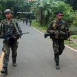 Philippine marines patrol a road on Basilan island, stronghold of the notorious Abu Sayyaf kidnap-for-ransom group, who killed nine in a dawn attack Monday according to police