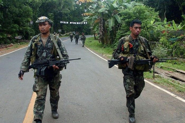 Philippine marines patrol a road on Basilan island, stronghold of the notorious Abu Sayyaf kidnap-for-ransom group, who killed nine in a dawn attack Monday according to police