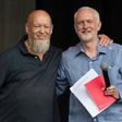 Britain's opposition Labour party leader Jeremy Corbyn (R) pictured with festival founder Michael Eavis on the Pyramid Stage at the Glastonbury Festival near the village of Pilton in Somerset, south-west England on June 24, 2017