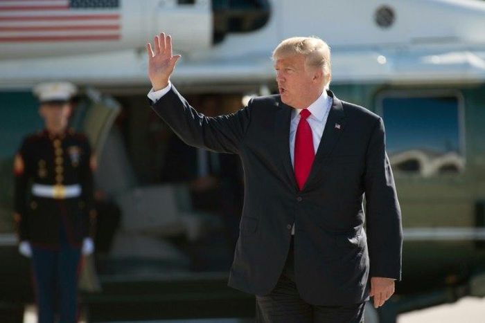 US President Donald Trump waves as he boards Airforce One after the G20 Summit in Hamburg, Germany, likely the stormiest such gathering in years