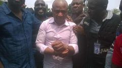Evans flanked by security operatives