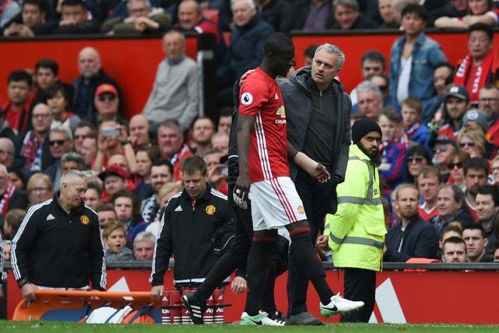 Manchester United's defender Eric Bailly (L) talks with manager Jose Mourinho during an April 2017 match